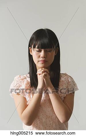 Japanese young woman praying View Large Photo Image Stock Photography - Japanese young woman praying. Fotosearch