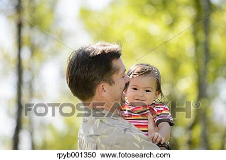 Kid and dad playing in a city park View Large Photo Image Stock Image - Kid and dad playing in a city park. Fotosearch