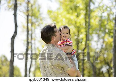 Kid and dad playing in a city park View Large Photo Image Stock Photo - Kid and dad playing in a city park. Fotosearch