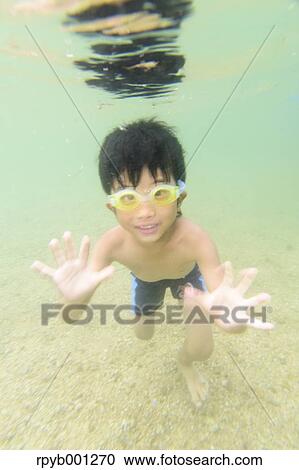 Stock Image - Kid at the beach. Fotosearch