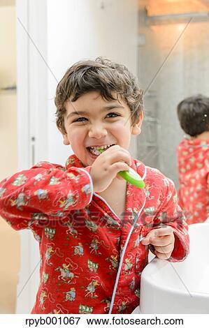 Kid brushing teeth in a pijama View Large Photo Image Stock Photo - Kid brushing teeth in a pijama. Fotosearch