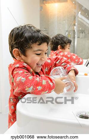 Kid brushing teeth in a pijama View Large Photo Image Stock Photo - Kid brushing teeth in a pijama. Fotosearch