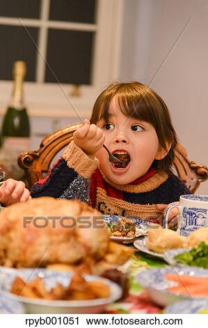 Kid eating in the house at Christmas View Large Photo Image Stock Image - Kid eating in the house at Christmas. Fotosearch