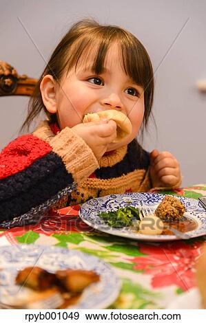 Kid eating in the house at Christmas View Large Photo Image Stock Photo - Kid eating in the house at Christmas. Fotosearch