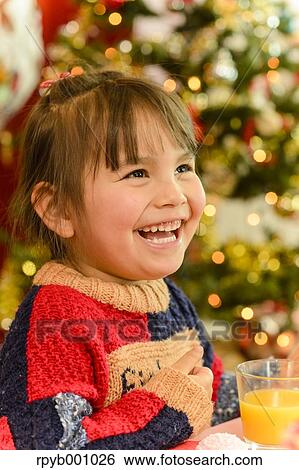 Kid eating in the house at Christmas View Large Photo Image Stock Photograph - Kid eating in the house at Christmas. Fotosearch