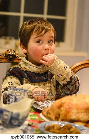 Kid eating in the house at Christmas View Large Photo Image Stock Photography - Kid eating in the house at Christmas. Fotosearch