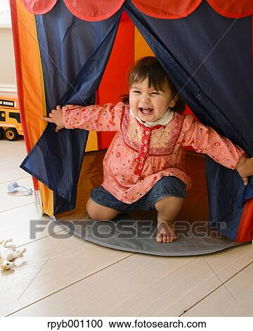 Kid playing in a children tent View Large Photo Image Stock Image - Kid playing in a children tent. Fotosearch