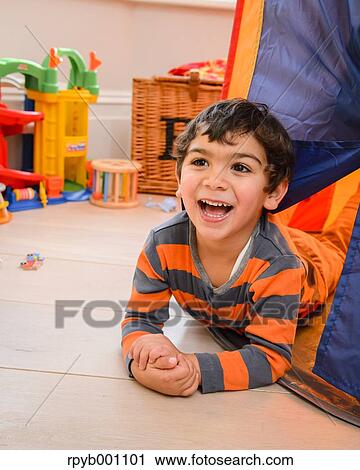 Kid playing in a children tent View Large Photo Image Stock Image - Kid playing in a children tent. Fotosearch