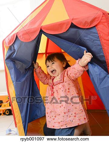 Kid playing in a children tent View Large Photo Image Stock Photo - Kid playing in a children tent. Fotosearch