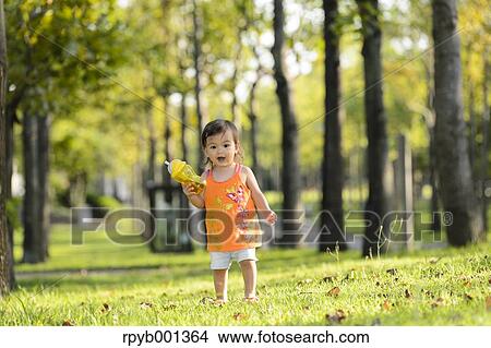 Kid playing in a city park View Large Photo Image Picture - Kid playing in a city park. Fotosearch