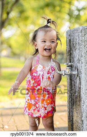 Picture - Kid playing in a city park. Fotosearch