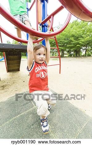 Kid playing in a city park View Large Photo Image Stock Image - Kid playing in a city park. Fotosearch