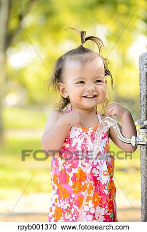 Stock Image - Kid playing in a city park. Fotosearch