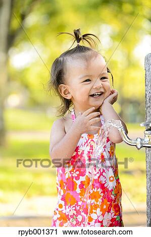Kid playing in a city park View Large Photo Image Stock Image - Kid playing in a city park. Fotosearch