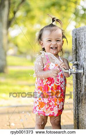 Kid playing in a city park View Large Photo Image Stock Image - Kid playing in a city park. Fotosearch