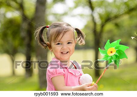 Stock Image - Kid playing in a city park. Fotosearch