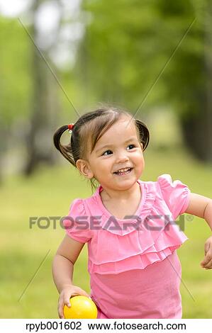 Kid playing in a city park View Large Photo Image Stock Image - Kid playing in a city park. Fotosearch