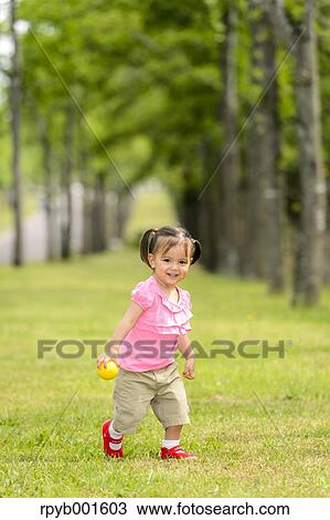 Kid playing in a city park View Large Photo Image Stock Image - Kid playing in a city park. Fotosearch