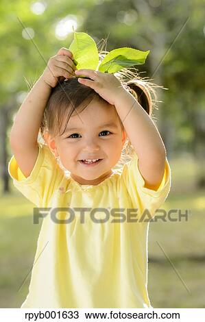 Kid playing in a city park View Large Photo Image Stock Image - Kid playing in a city park. Fotosearch
