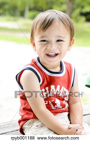 Kid playing in a city park View Large Photo Image Stock Photo - Kid playing in a city park. Fotosearch
