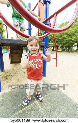 Kid playing in a city park View Large Photo Image Stock Photo - Kid playing in a city park. Fotosearch