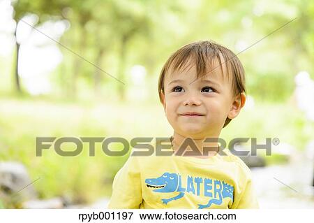 Kid playing in a city park View Large Photo Image Stock Photo - Kid playing in a city park. Fotosearch