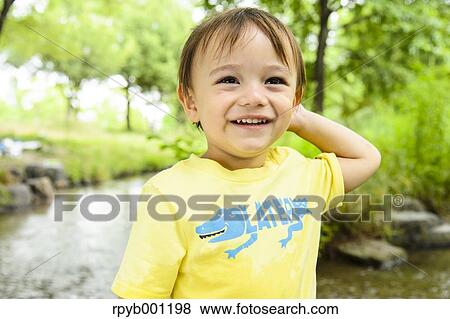 Kid playing in a city park View Large Photo Image Stock Photo - Kid playing in a city park. Fotosearch
