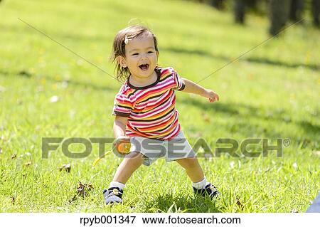 Kid playing in a city park View Large Photo Image Stock Photo - Kid playing in a city park. Fotosearch