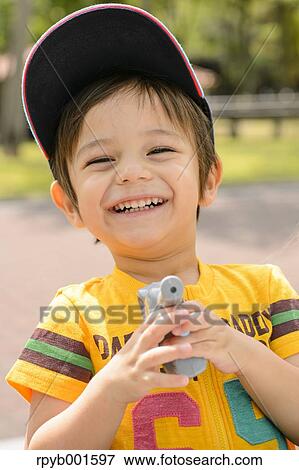 Kid playing in a city park View Large Photo Image Stock Photo - Kid playing in a city park. Fotosearch