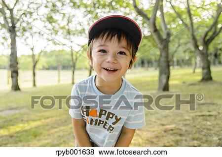 Kid playing in a city park View Large Photo Image Stock Photo - Kid playing in a city park. Fotosearch