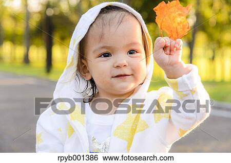 Kid playing in a city park View Large Photo Image Stock Photograph - Kid playing in a city park. Fotosearch