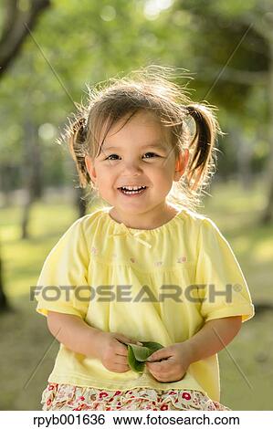 Stock Photograph - Kid playing in a city park. Fotosearch