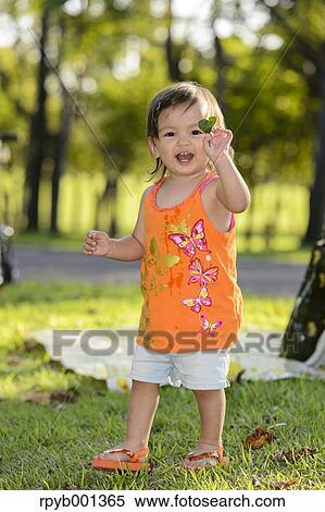 Stock Photography - Kid playing in a city park. Fotosearch