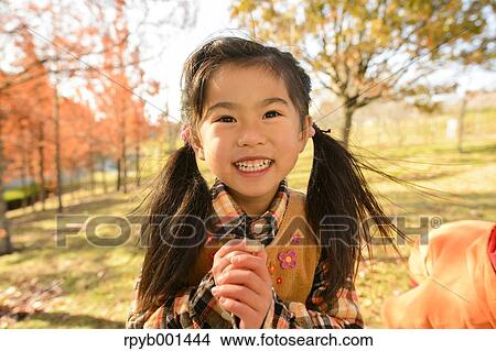 Kid playing in a park View Large Photo Image Picture - Kid playing in a park. Fotosearch