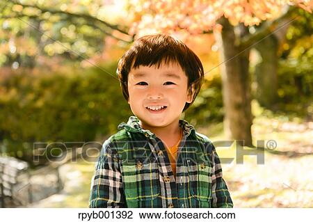 Stock Image - Kid playing in a park. Fotosearch