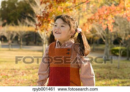 Kid playing in a park View Large Photo Image Stock Image - Kid playing in a park. Fotosearch