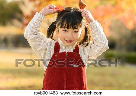 Kid playing in a park View Large Photo Image Stock Image - Kid playing in a park. Fotosearch
