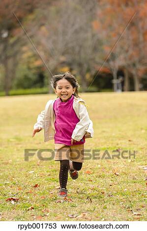 Kid playing in a park View Large Photo Image Stock Image - Kid playing in a park. Fotosearch