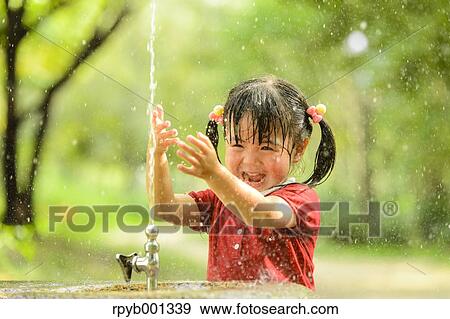 Stock Photo - Kid playing in a park. Fotosearch