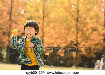 Stock Photo - Kid playing in a park. Fotosearch