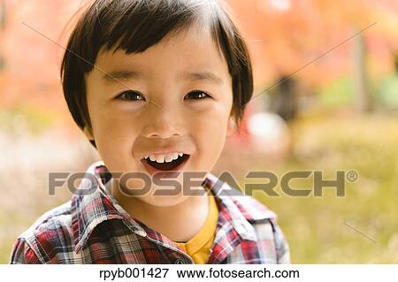 Kid playing in a park View Large Photo Image Stock Photo - Kid playing in a park. Fotosearch
