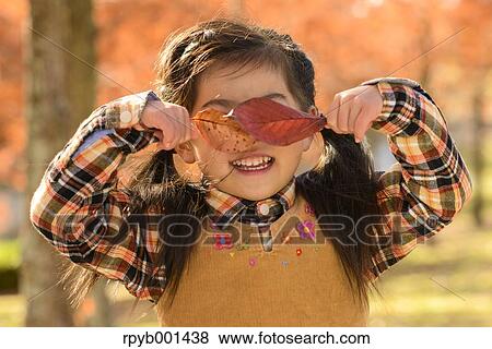 Kid playing in a park View Large Photo Image Stock Photo - Kid playing in a park. Fotosearch
