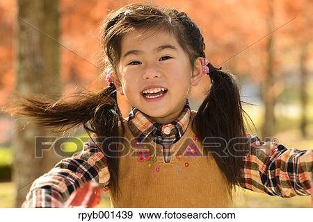 Stock Photo - Kid playing in a park. Fotosearch