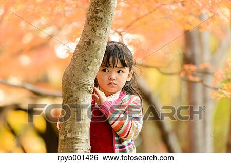 Kid playing in a park View Large Photo Image Stock Photograph - Kid playing in a park. Fotosearch