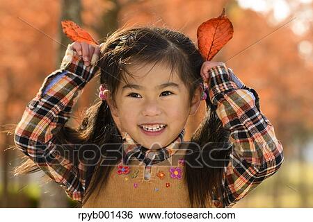 Kid playing in a park View Large Photo Image Stock Photograph - Kid playing in a park. Fotosearch