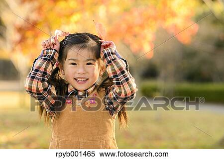 Kid playing in a park View Large Photo Image Stock Photography - Kid playing in a park. Fotosearch