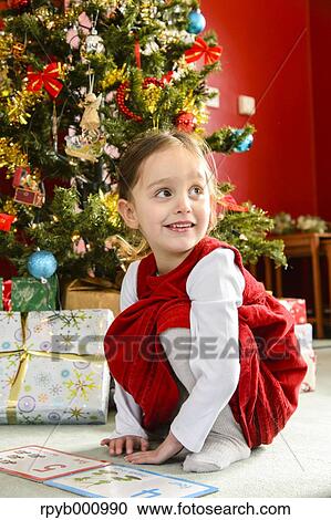 Stock Image - Kid playing in the house at Christmas. Fotosearch
