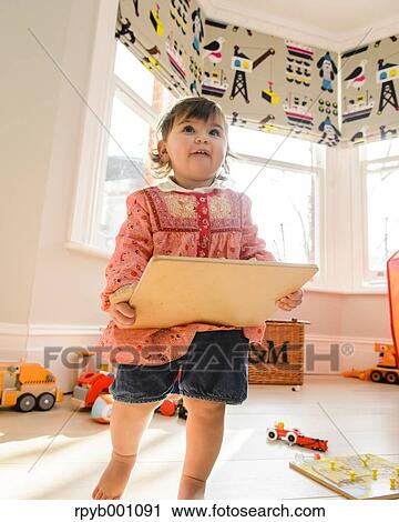 Kid playing in the house View Large Photo Image Stock Image - Kid playing in the house. Fotosearch