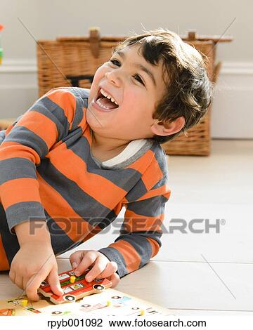 Kid playing in the house View Large Photo Image Stock Image - Kid playing in the house. Fotosearch