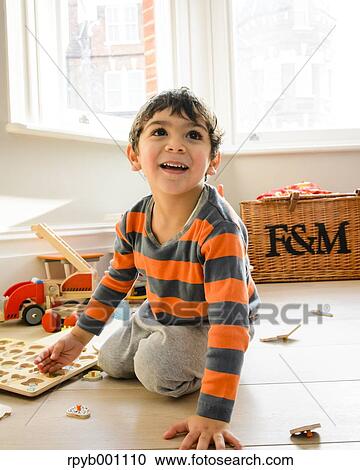 Kid playing in the house View Large Photo Image Stock Image - Kid playing in the house. Fotosearch